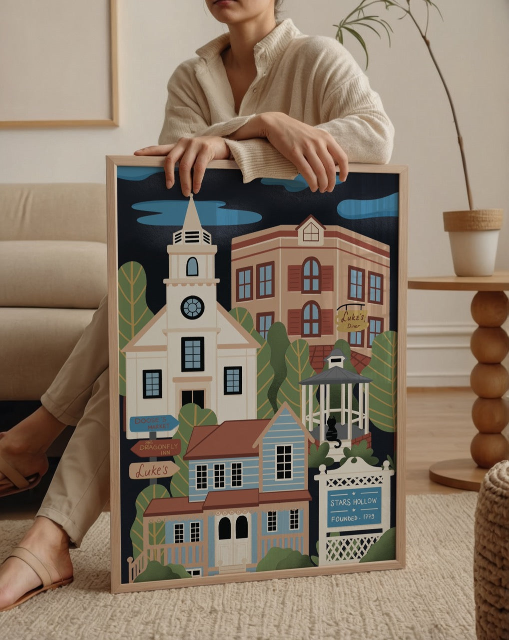Özge Özcan Stars Hollow posteri; Gilmore Girls kasabasını yansıtan Luke’s Diner ve Doose’s Market illüstrasyonu.